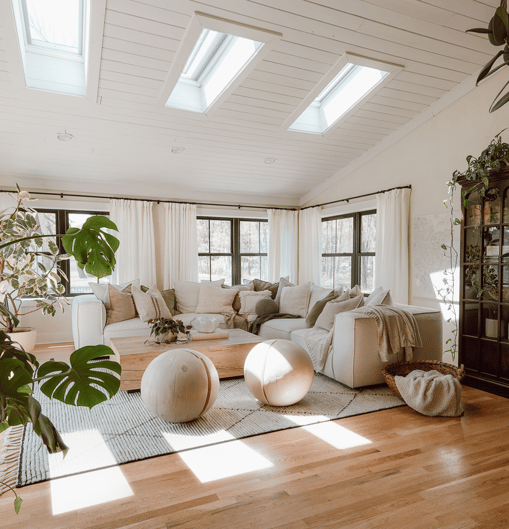 Green building design with skylights featuring the interior of a living room with natural light