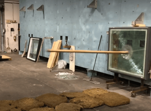 A 2'X4' hits a skylight as part of the first round of missle impact testing