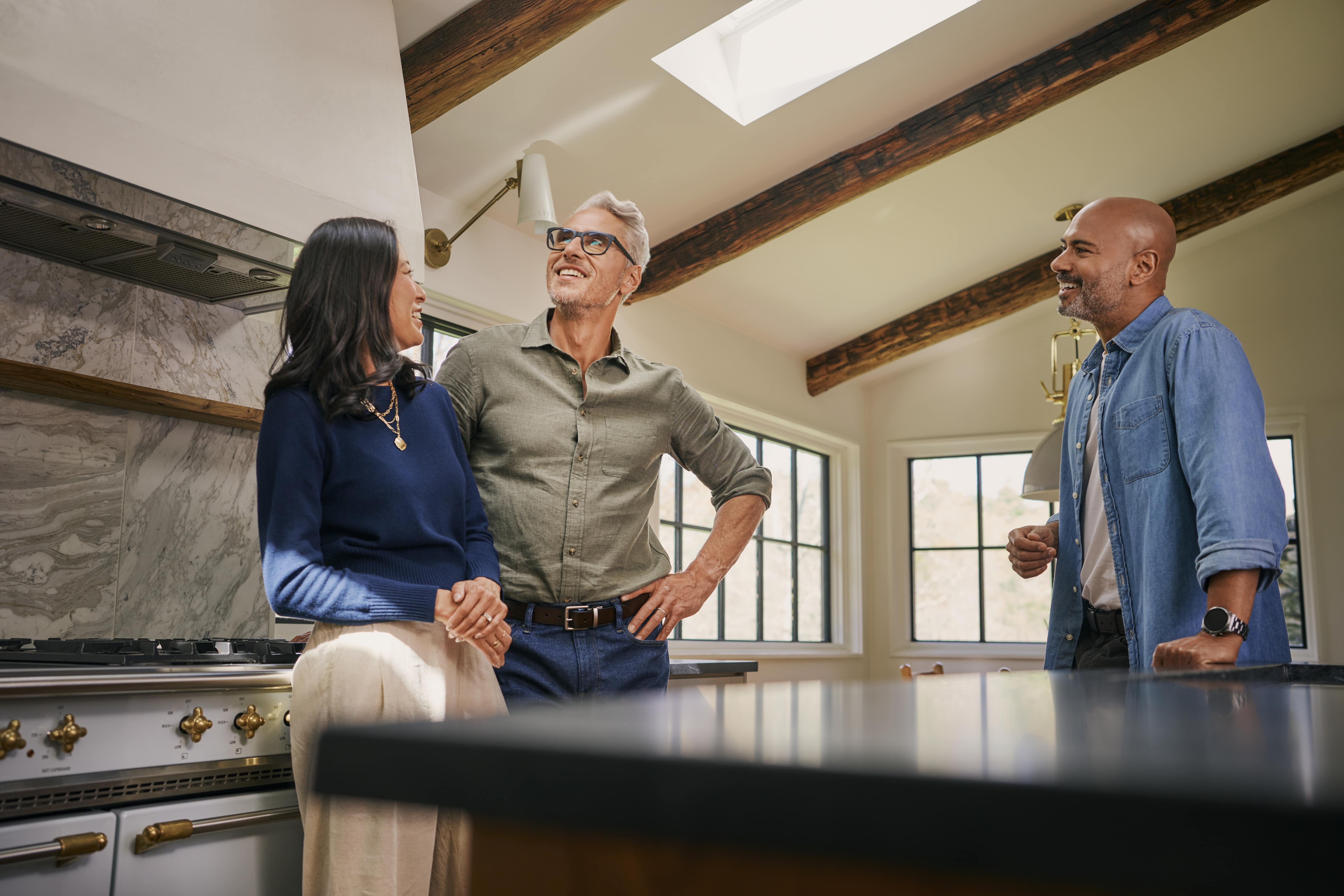 Installer discussing skylight installation cost with homeowners