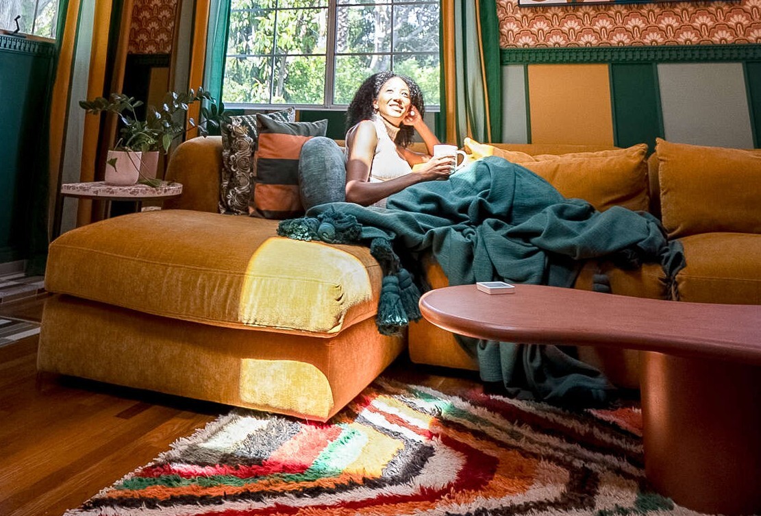 Woman basking in the glow of Skylight Systems after luxury home renovations