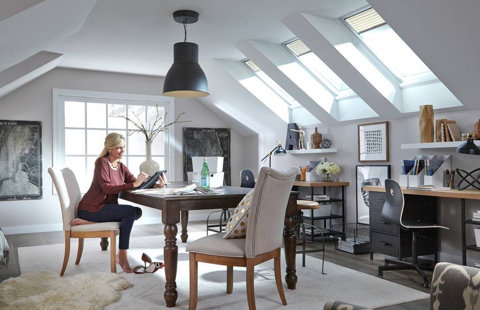 woman enjoying skylights in her bonus room which is a a top eco-friendly home upgrade